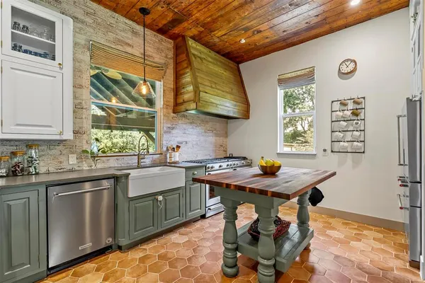 a view of a kitchen with a table and chairs in it