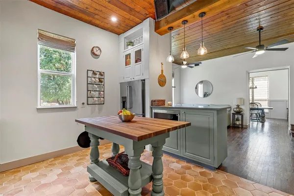 a kitchen with stainless steel appliances granite countertop a refrigerator and a stove