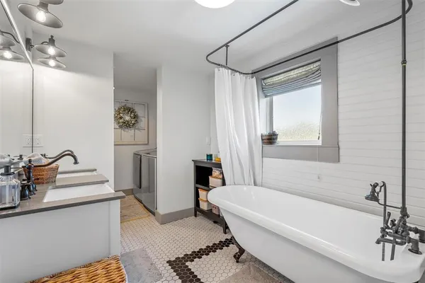 a bathroom with double vanity sinks a vanity two mirror and shower