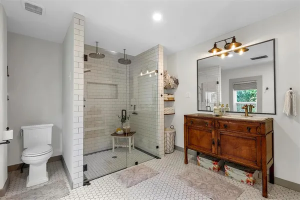 a bathroom with a sink a mirror and a shower