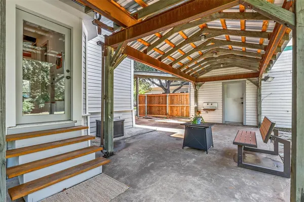a view of a patio with a table and chairs