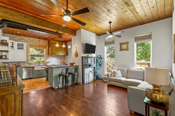 a living room with furniture and a wooden floor