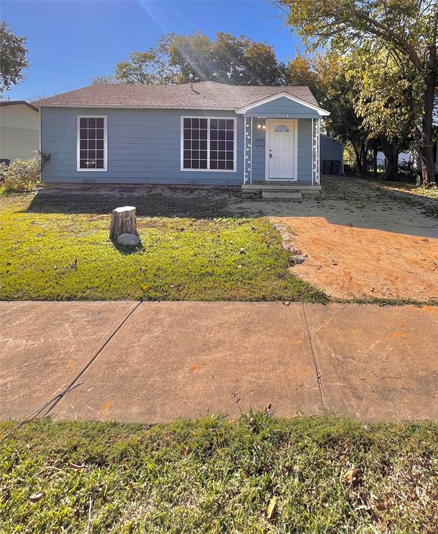 1324 Maple Drive Garland, TX 75040 - Photo 1 of 10 a front view of a house with a yard and garage