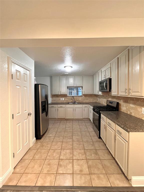1324 Maple Drive Garland, TX 75040 - Photo 2 of 10 a large kitchen with stainless steel appliances lots of counter top space and cabinets