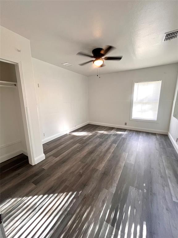 1324 Maple Drive Garland, TX 75040 - Photo 5 of 10 wooden floor in an empty room with a fireplace