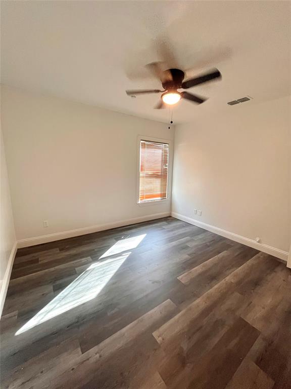 1324 Maple Drive Garland, TX 75040 - Photo 8 of 10 an empty room with windows and fan
