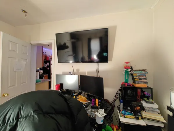 a bedroom with a bed and a flat screen tv