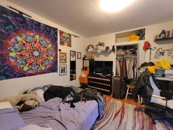 a bedroom with a bed and dresser