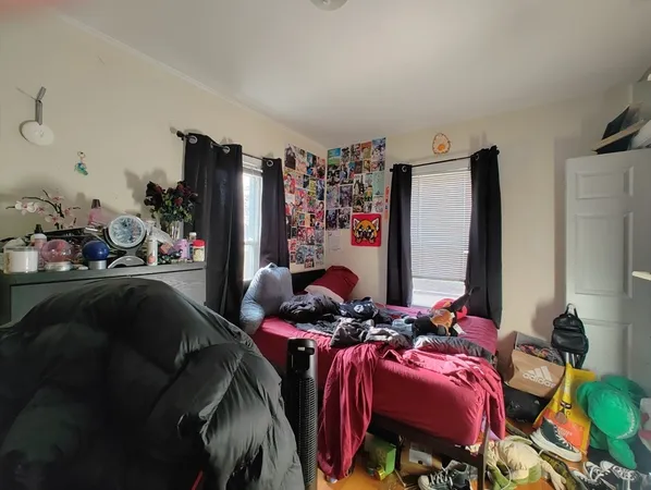 a bedroom with furniture and a mirror