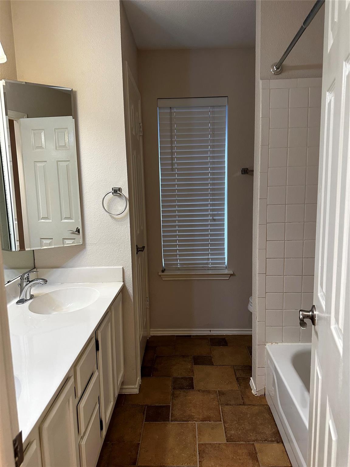 8007 Bounty Trail Austin, TX 78749 - Photo 26 of 32 Functional full bathroom featuring a tub and vanity with ample counter space.