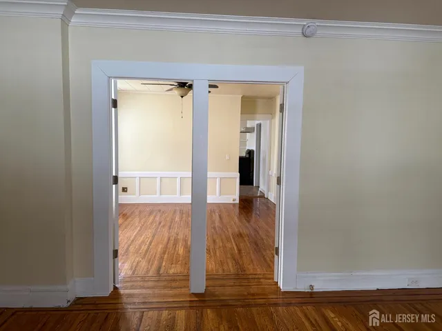 a view of walk in closet with wooden floor