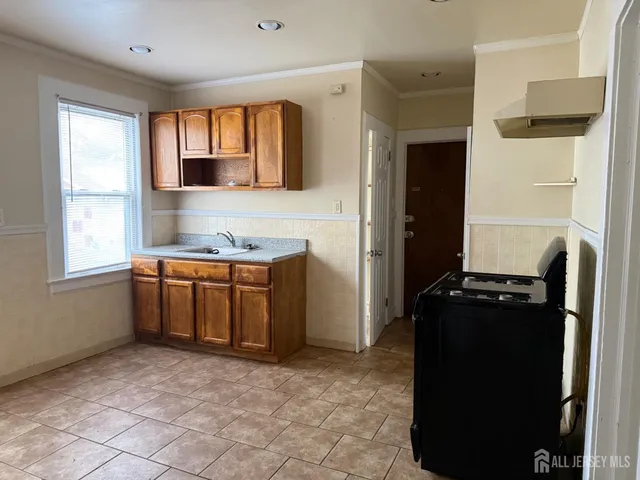 a kitchen with a refrigerator and a stove top oven