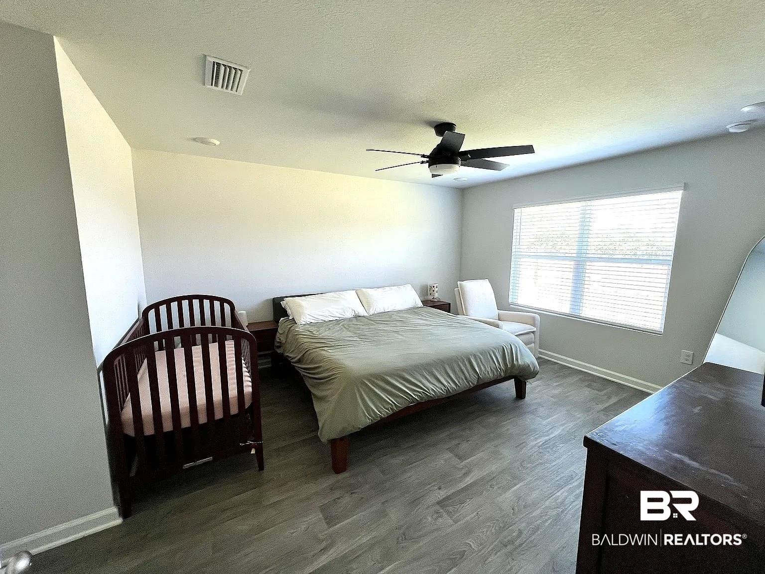 23915 Veranda Circle Elberta, AL 36530 - Photo 12 of 16 Bedroom with dark wood-style floors, a textured ceiling, and ceiling fan
