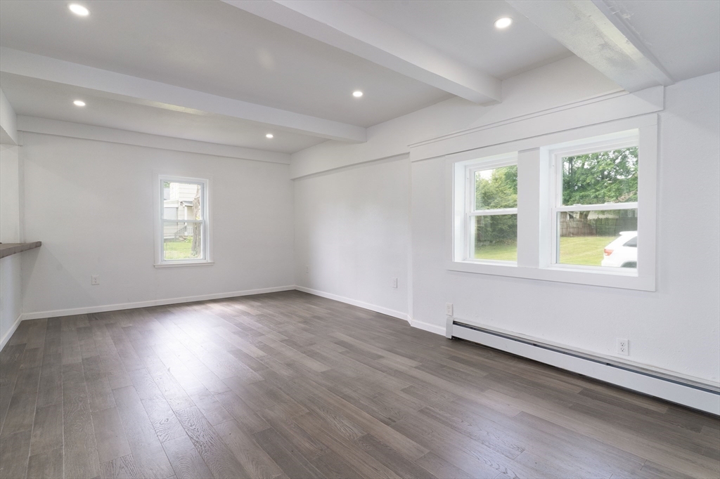 1240 South Main Street Palmer, MA 01069 - Photo 11 of 31 an empty room with wooden floor and windows