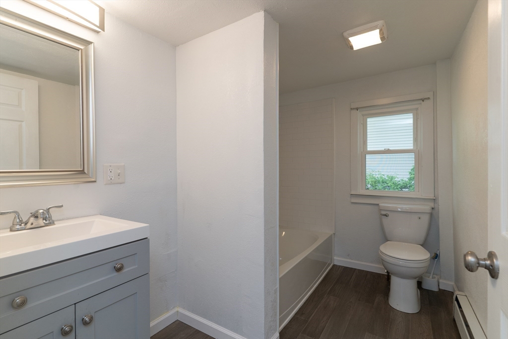 1240 South Main Street Palmer, MA 01069 - Photo 14 of 31 a bathroom with a toilet sink and mirror