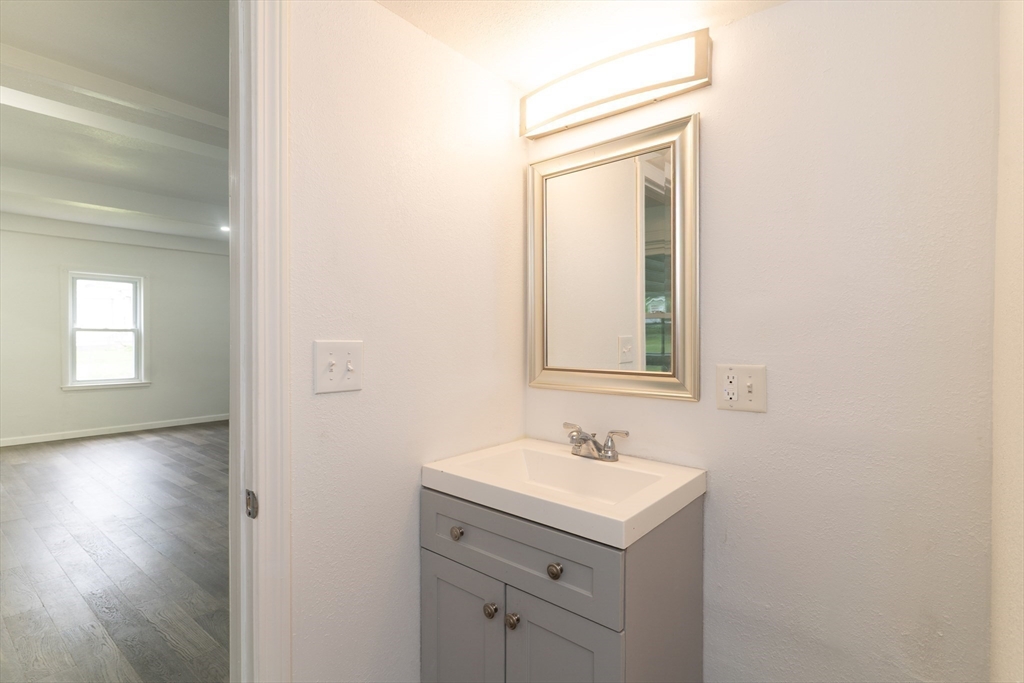 1240 South Main Street Palmer, MA 01069 - Photo 16 of 31 a bathroom with a sink vanity and mirror