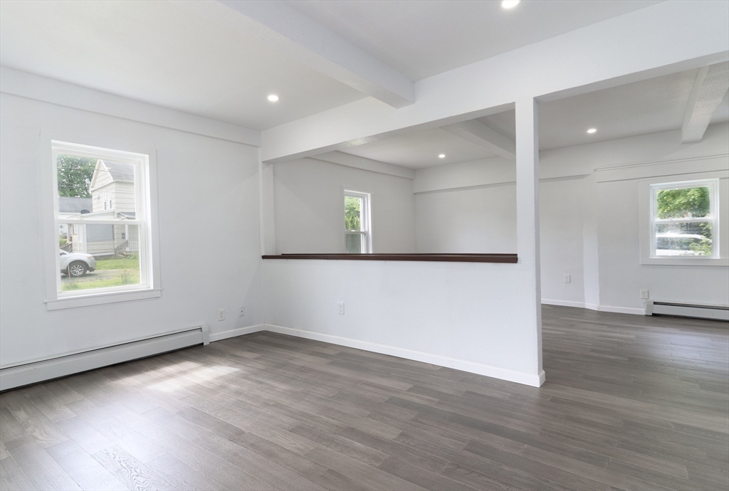 1240 South Main Street Palmer, MA 01069 - Photo 17 of 31 an empty room with wooden floor and windows