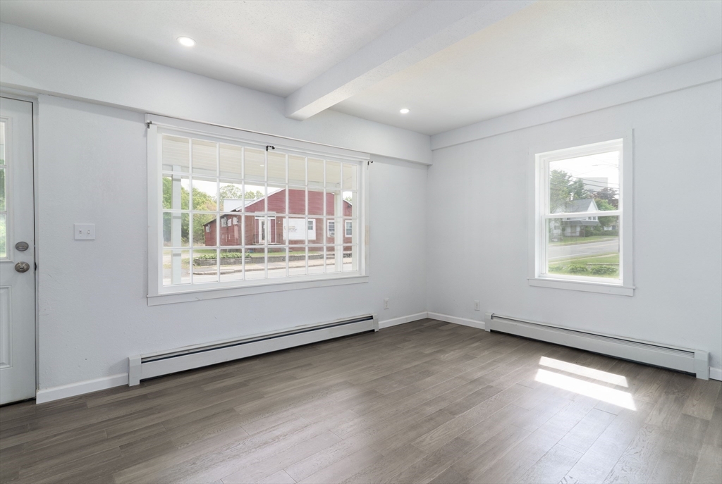 1240 South Main Street Palmer, MA 01069 - Photo 18 of 31 an empty room with wooden floor and windows