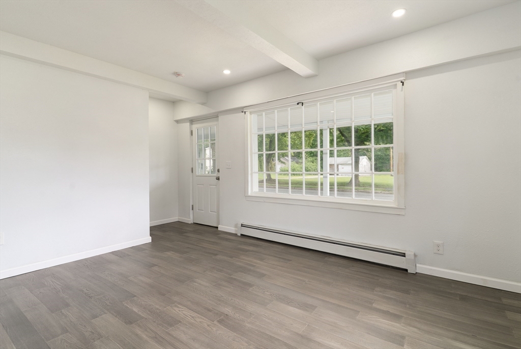 1240 South Main Street Palmer, MA 01069 - Photo 19 of 31 an empty room with wooden floor and windows