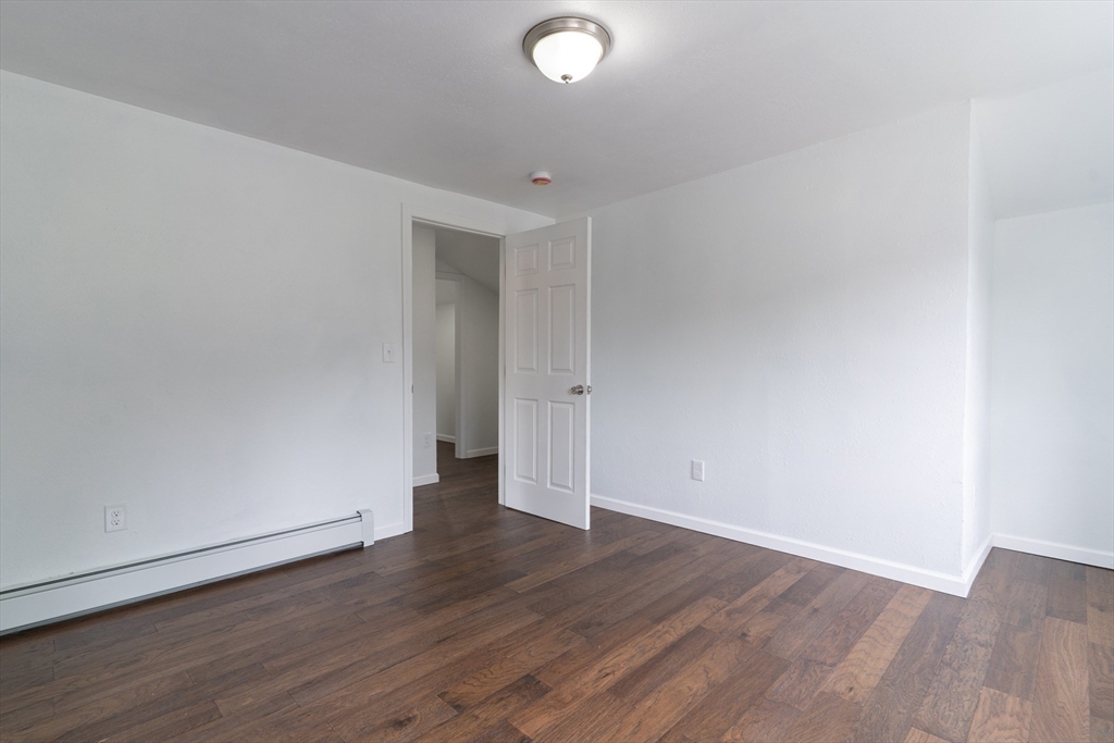 1240 South Main Street Palmer, MA 01069 - Photo 20 of 31 an empty room with wooden floor and windows