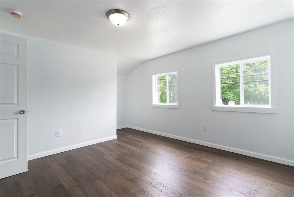 1240 South Main Street Palmer, MA 01069 - Photo 22 of 31 an empty room with wooden floor and windows