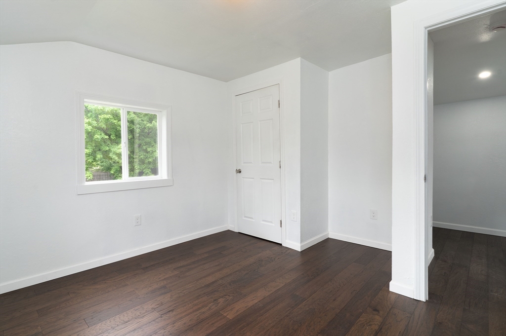 1240 South Main Street Palmer, MA 01069 - Photo 24 of 31 an empty room with wooden floor and windows