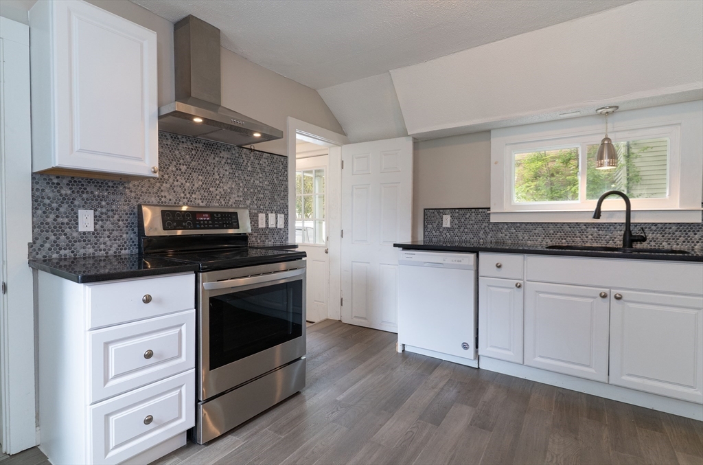 1240 South Main Street Palmer, MA 01069 - Photo 4 of 31 a kitchen with granite countertop white cabinets and white appliances