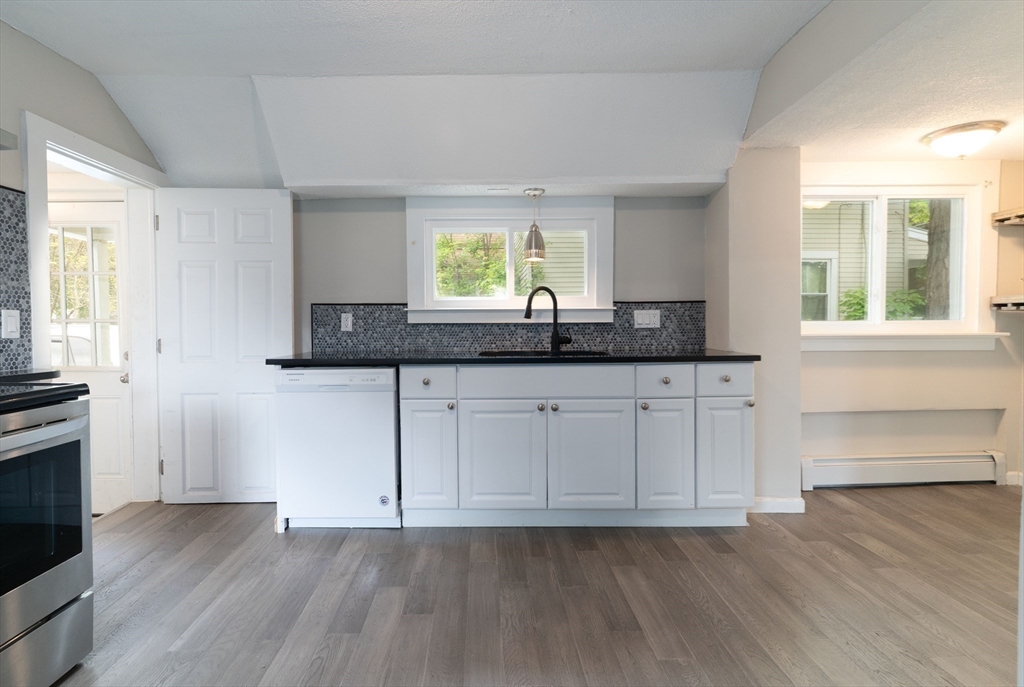 1240 South Main Street Palmer, MA 01069 - Photo 5 of 31 a kitchen with granite countertop stainless steel appliances a sink and a window