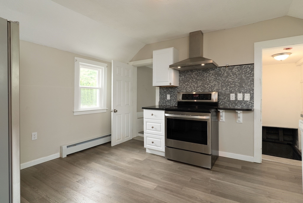 1240 South Main Street Palmer, MA 01069 - Photo 7 of 31 a kitchen with a stove and a microwave
