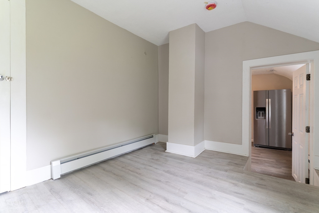 1240 South Main Street Palmer, MA 01069 - Photo 9 of 31 an empty room with wooden floor and windows
