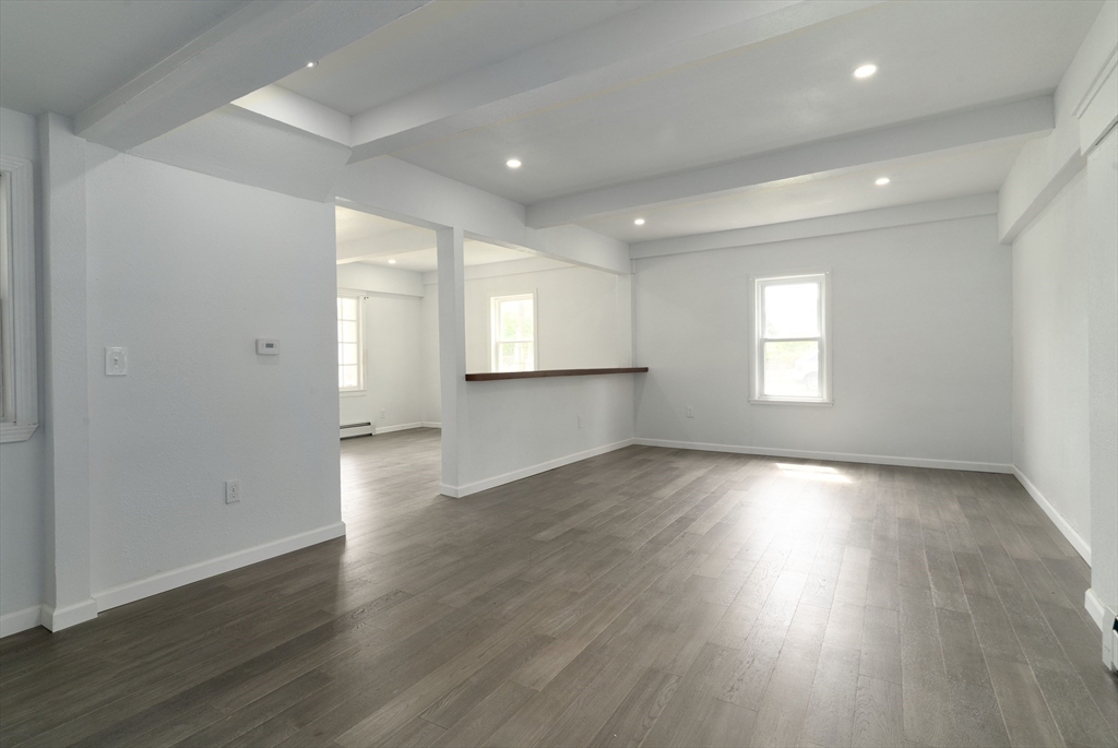 1240 South Main Street Palmer, MA 01069 - Photo 10 of 31 an empty room with wooden floor and windows