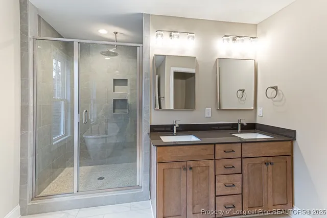 a bathroom with a granite countertop sink mirror and shower