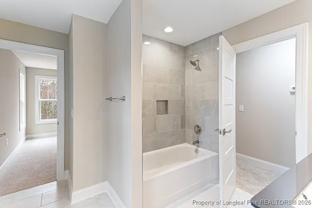 a bathroom with a bathtub a shower a sink and a toilet