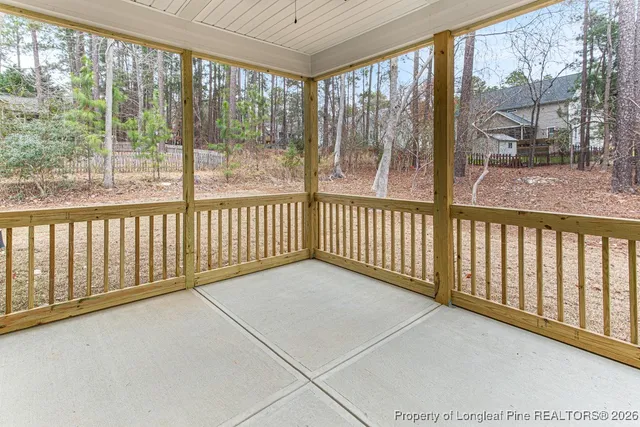 a view of a room with wooden floor and windows