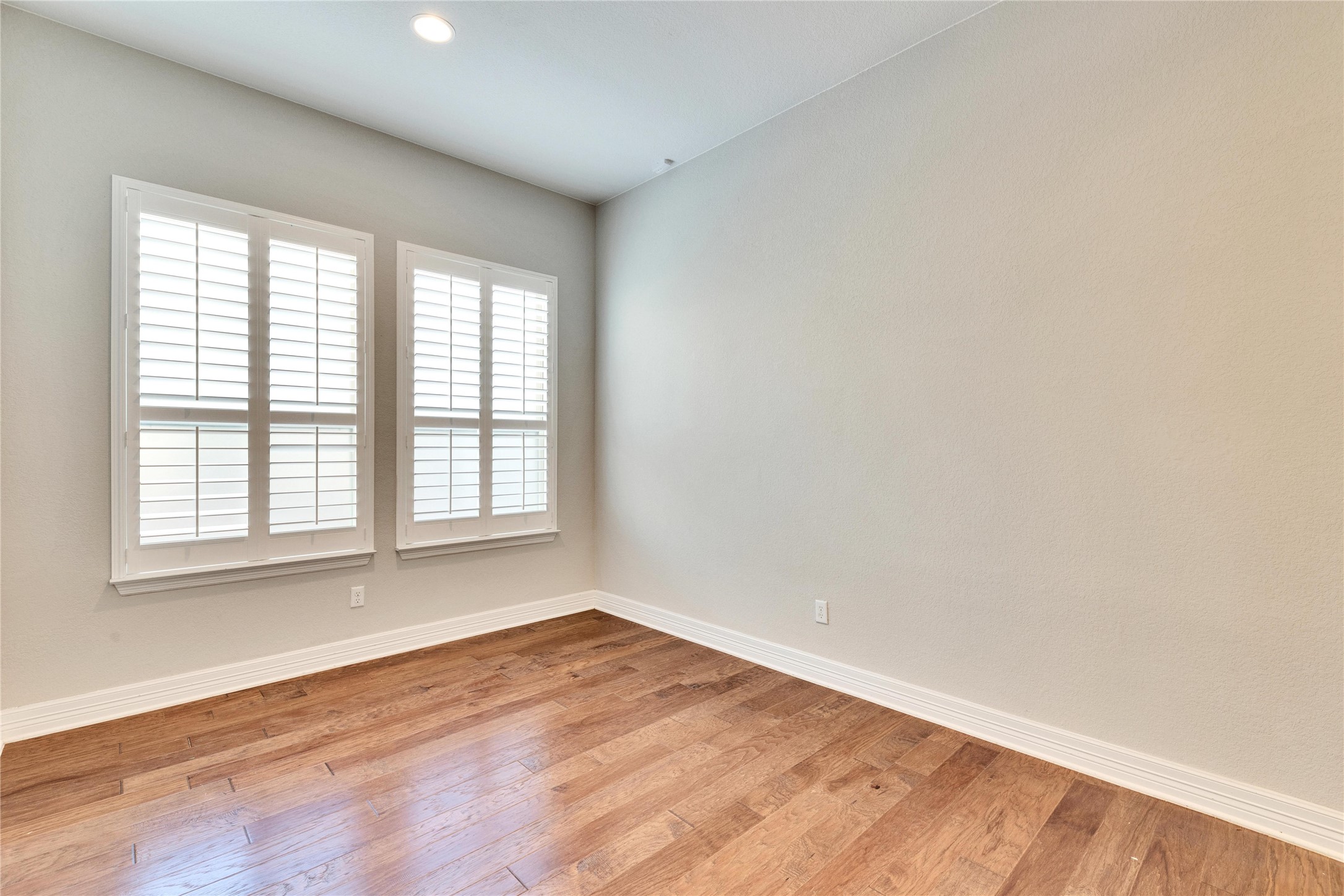 5213 Buchanan Draw Road Austin, TX 78738 - Photo 20 of 33 an empty room with wooden floor and windows
