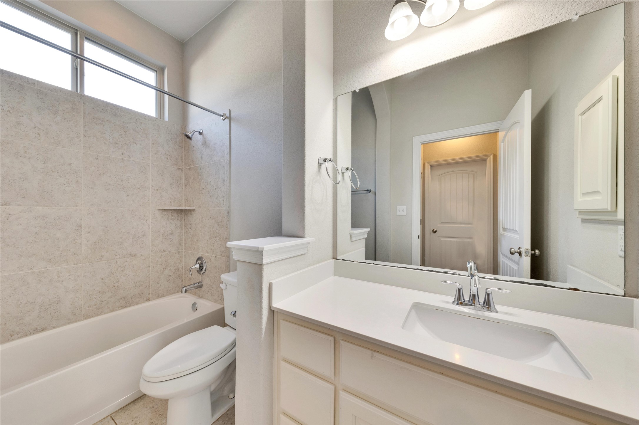 5213 Buchanan Draw Road Austin, TX 78738 - Photo 22 of 33 a bathroom with a granite countertop sink a toilet a mirror a bathtub and shower