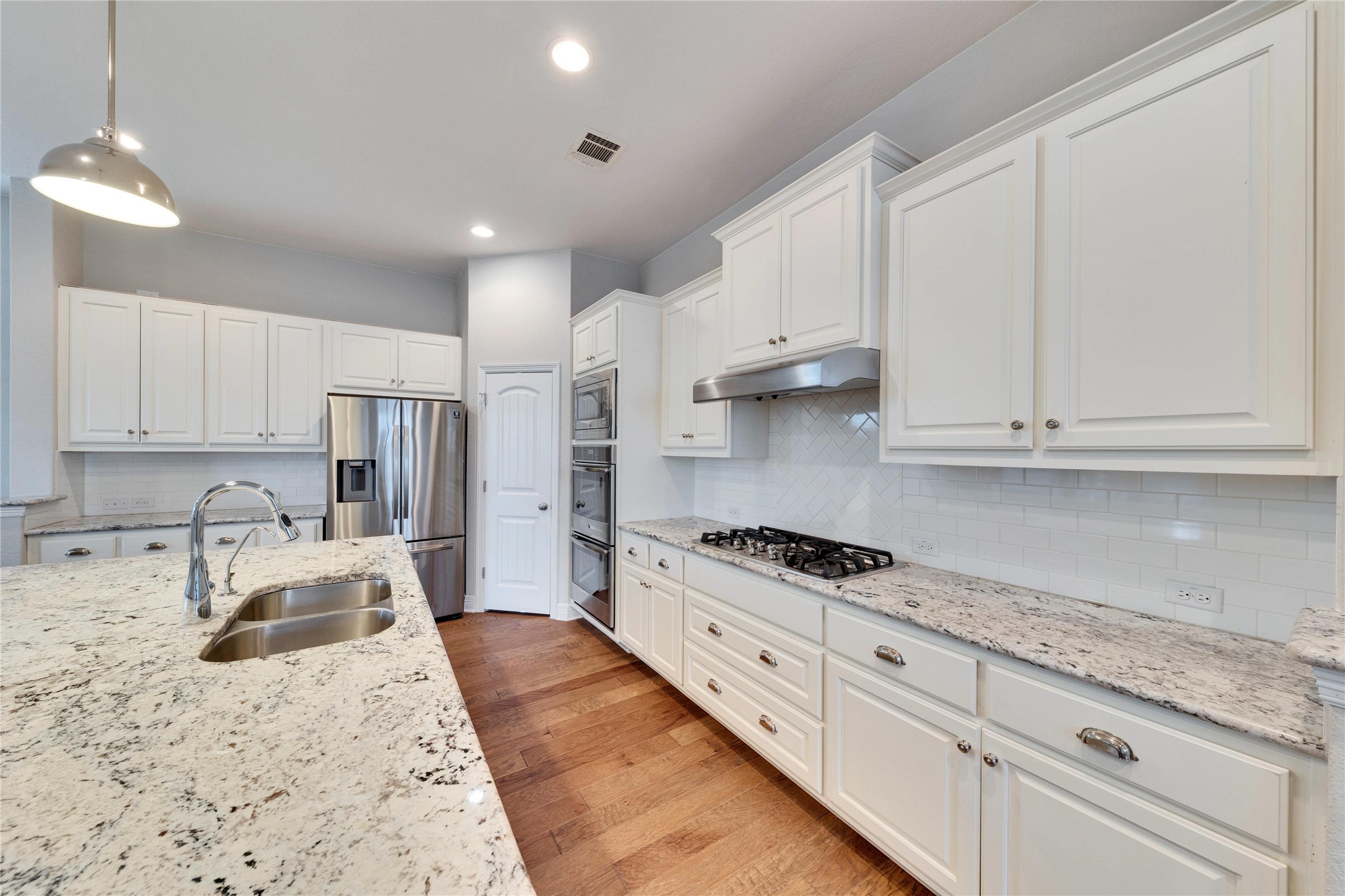5213 Buchanan Draw Road Austin, TX 78738 - Photo 4 of 33 a kitchen with stainless steel appliances granite countertop a sink stove and refrigerator