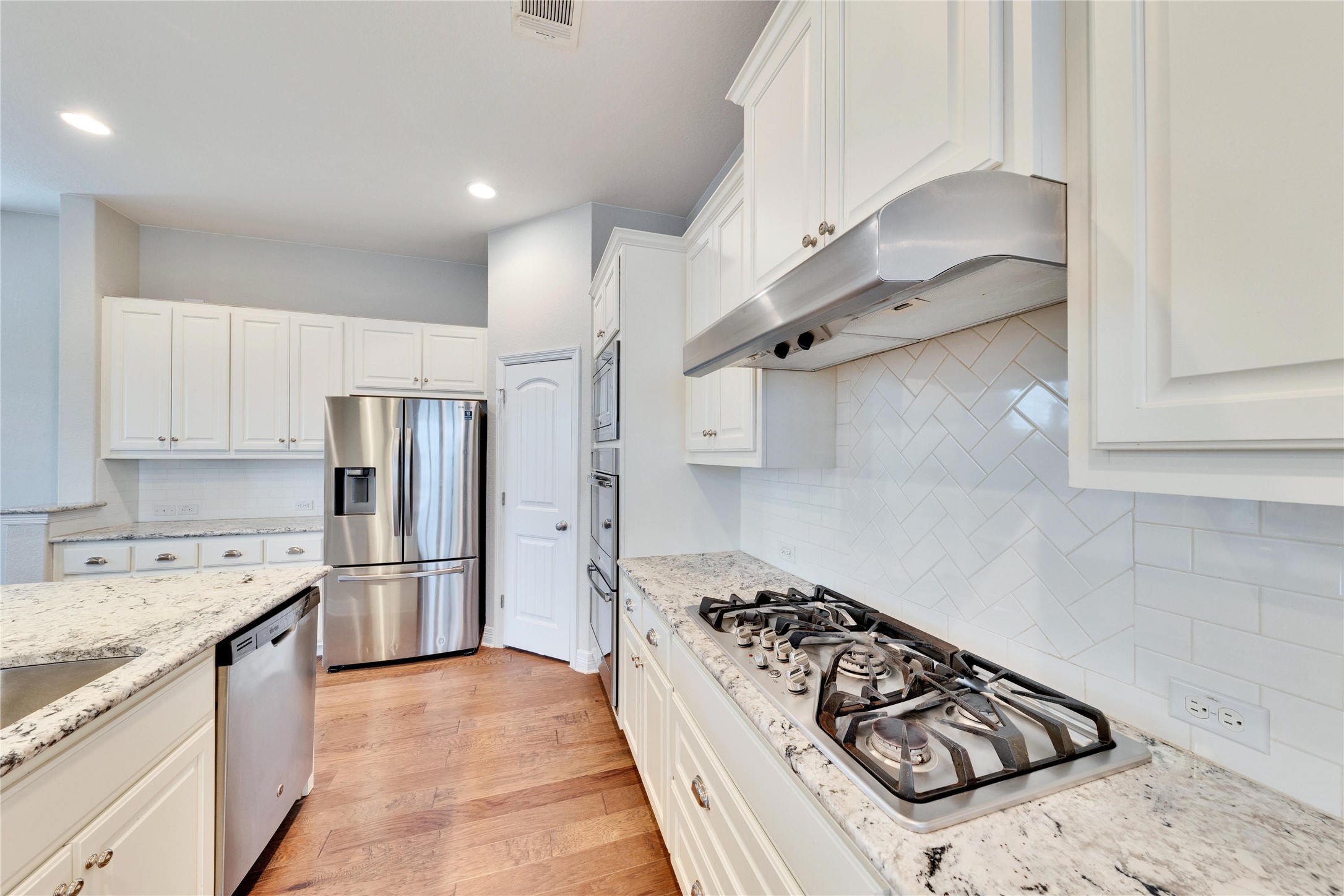 5213 Buchanan Draw Road Austin, TX 78738 - Photo 5 of 33 a kitchen with stainless steel appliances granite countertop a sink stove and refrigerator