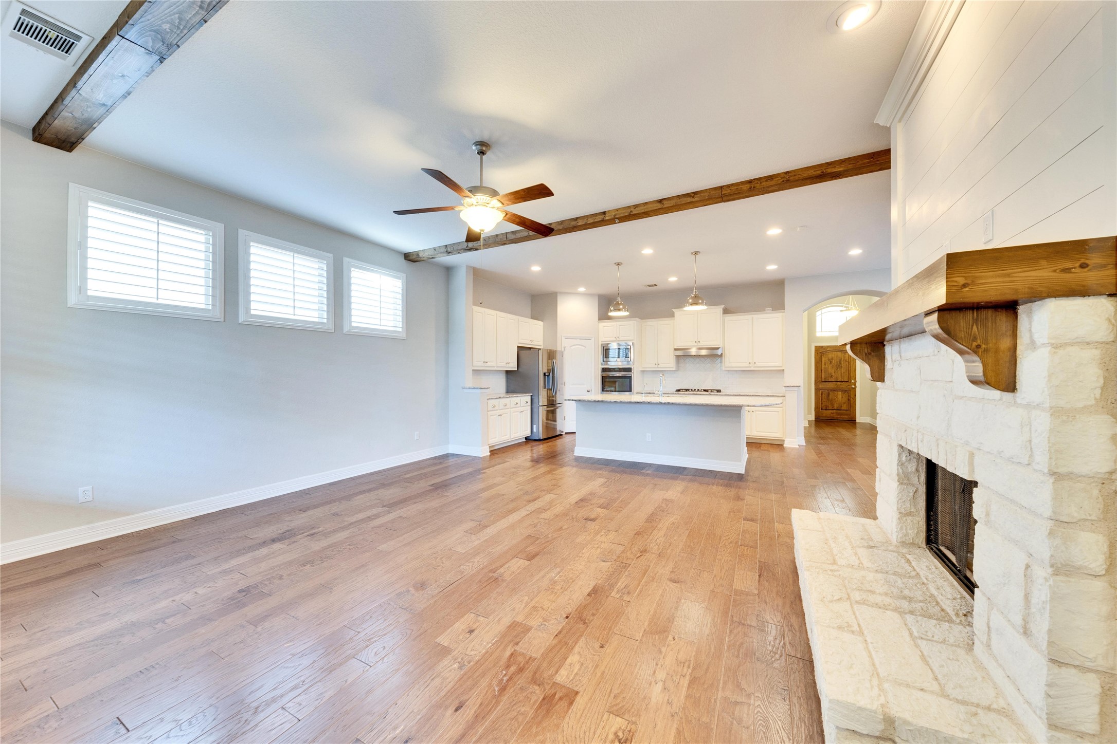 5213 Buchanan Draw Road Austin, TX 78738 - Photo 7 of 33 a view of large kitchen with a sink and a fireplace
