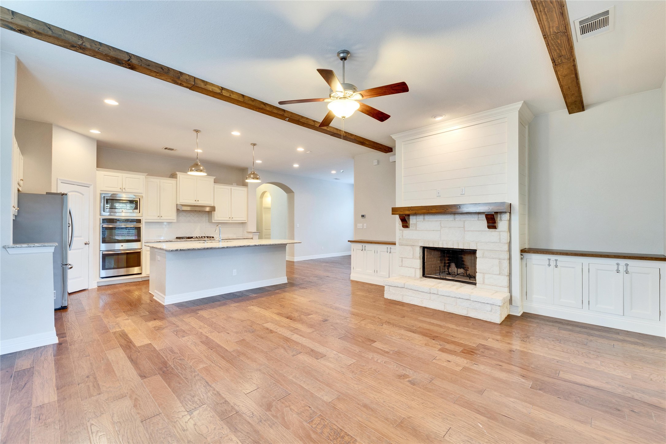 5213 Buchanan Draw Road Austin, TX 78738 - Photo 8 of 33 a view of kitchen with kitchen island wooden floor center island and stainless steel appliances