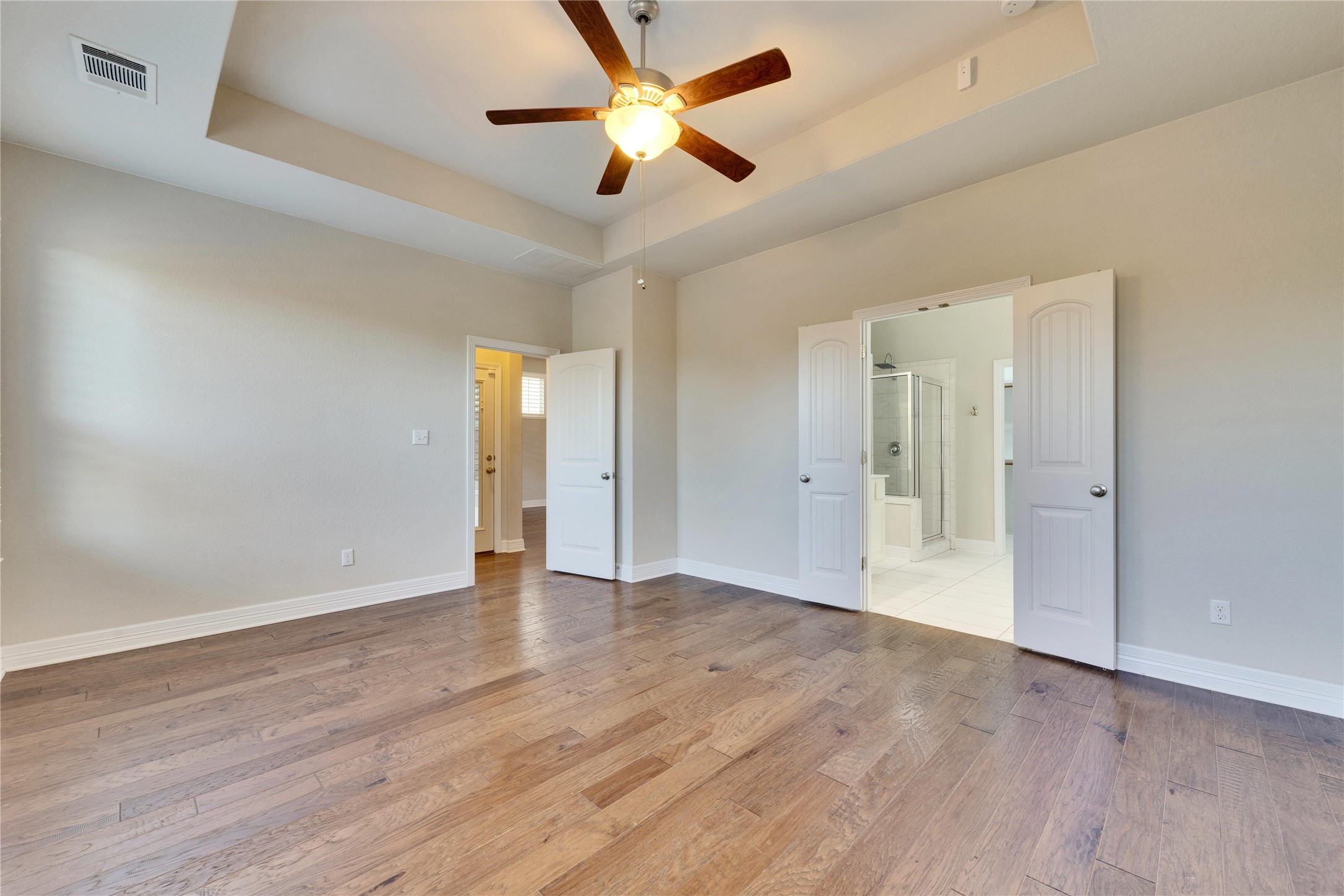 5213 Buchanan Draw Road Austin, TX 78738 - Photo 10 of 33 an empty room with wooden floor and a ceiling fan