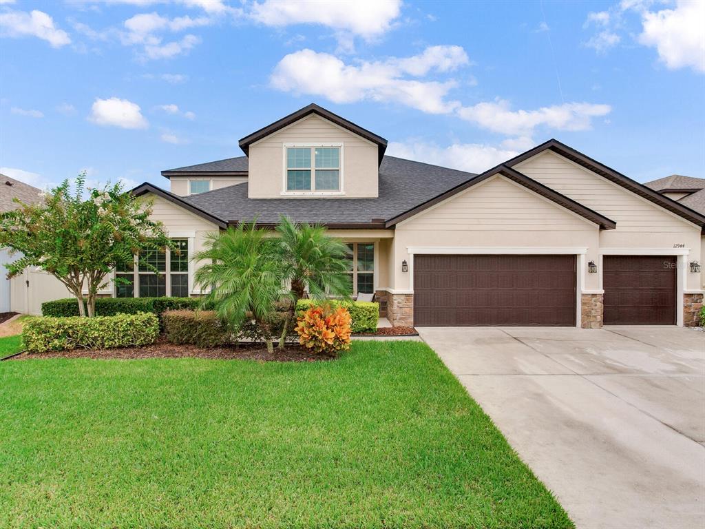 a front view of a house with a yard and garage