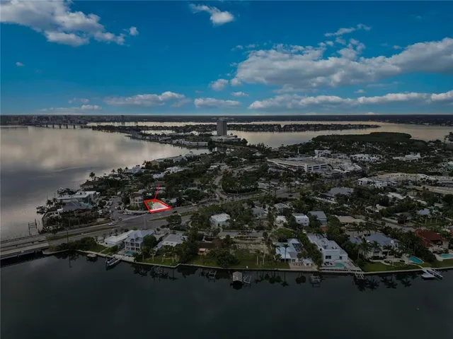 an aerial view of a city with lots of residential buildings ocean and mountain view