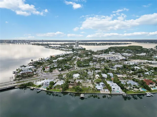 an aerial view of lake with residential house with outdoor space