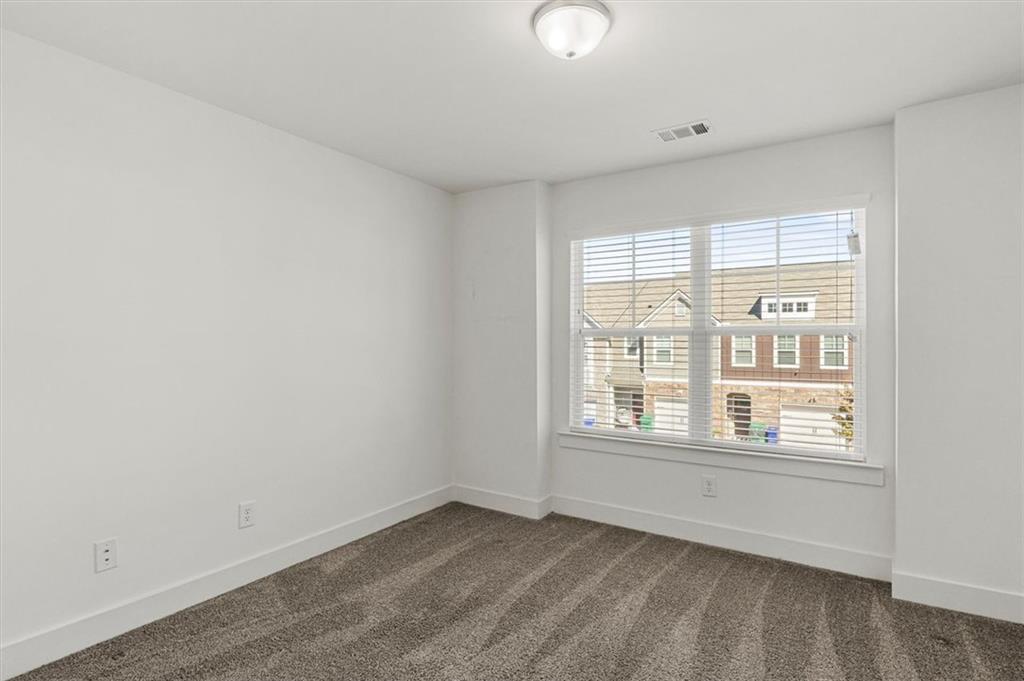 6347 Princeton Ridge Drive Lithonia, GA 30058 - Photo 14 of 28 an empty room with wooden floor and windows