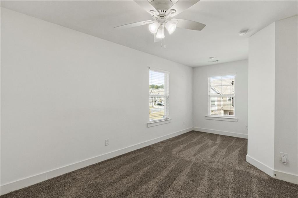6347 Princeton Ridge Drive Lithonia, GA 30058 - Photo 15 of 28 an empty room with windows and fan