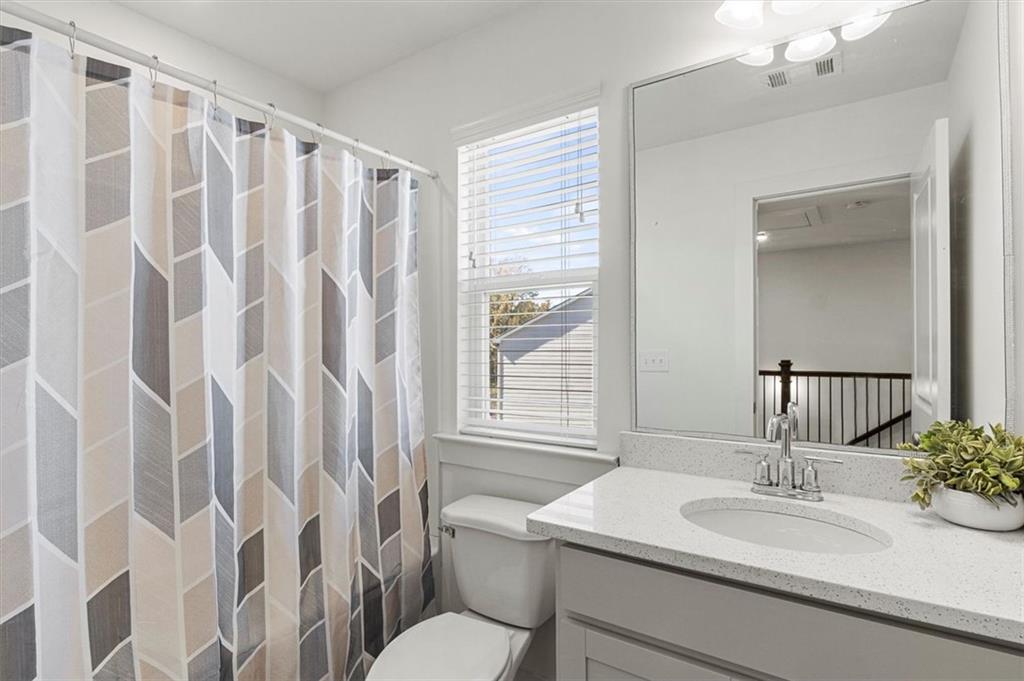 6347 Princeton Ridge Drive Lithonia, GA 30058 - Photo 19 of 28 a bathroom with a granite countertop sink and a mirror
