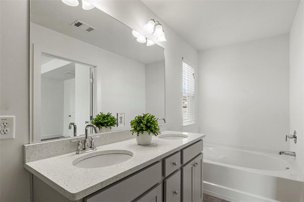6347 Princeton Ridge Drive Lithonia, GA 30058 - Photo 23 of 28 a bathroom with a sink and a mirror
