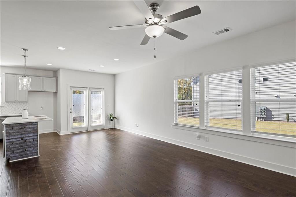 6347 Princeton Ridge Drive Lithonia, GA 30058 - Photo 6 of 28 a view of an empty room with a window and wooden floor
