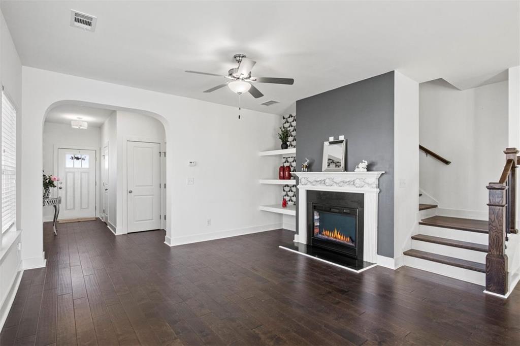 6347 Princeton Ridge Drive Lithonia, GA 30058 - Photo 8 of 28 a view of an empty room with wooden floor fireplace and a fire place